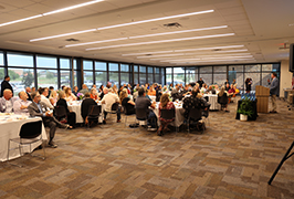  A group of people sit in a room